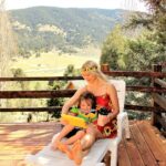 woman in yellow tank top sitting on brown wooden bench